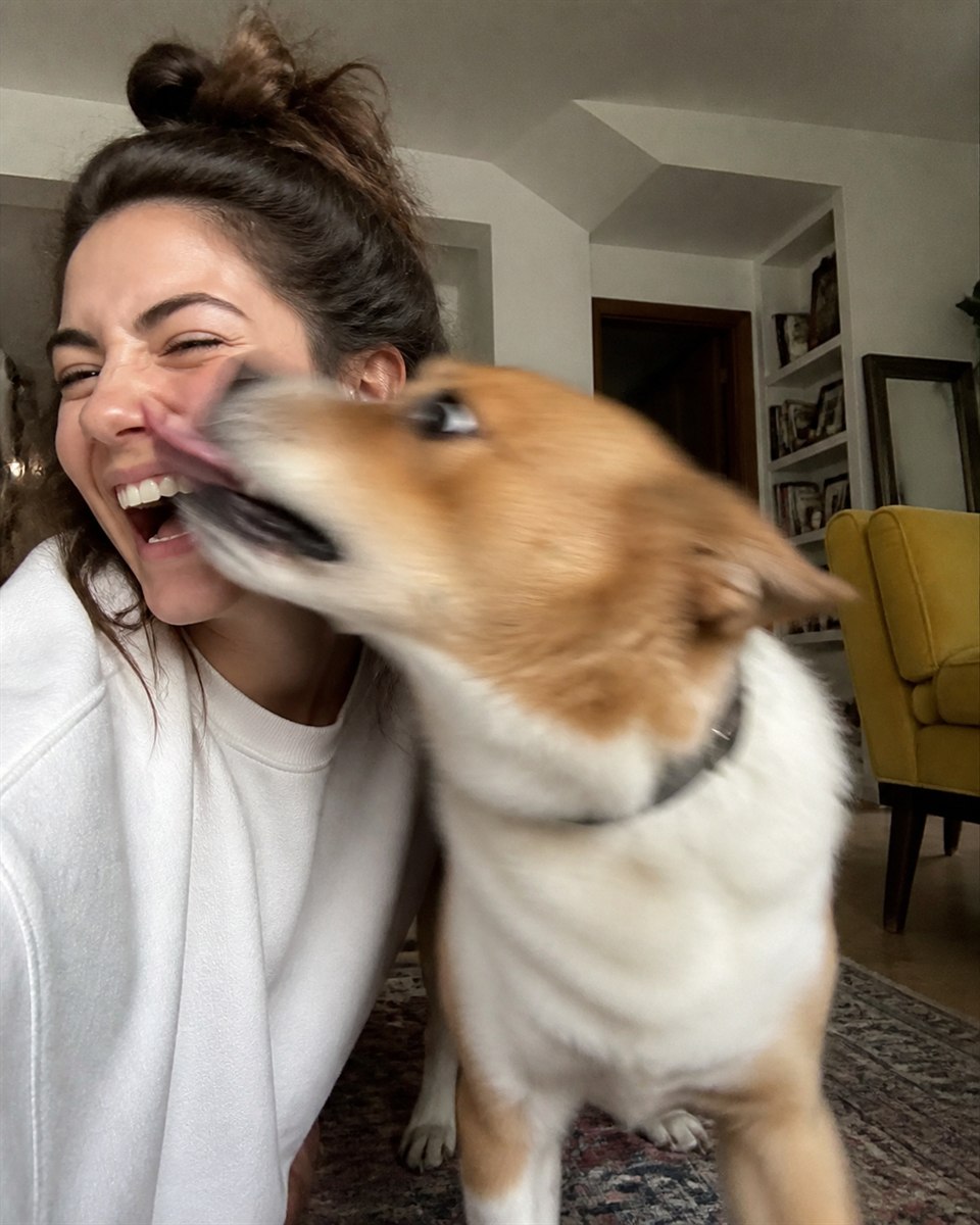 Pet creator sharing a playful moment with a dog